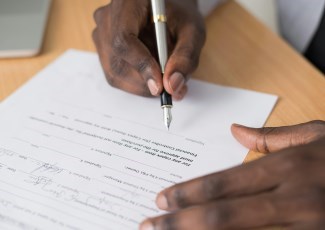 Photo of person signing form